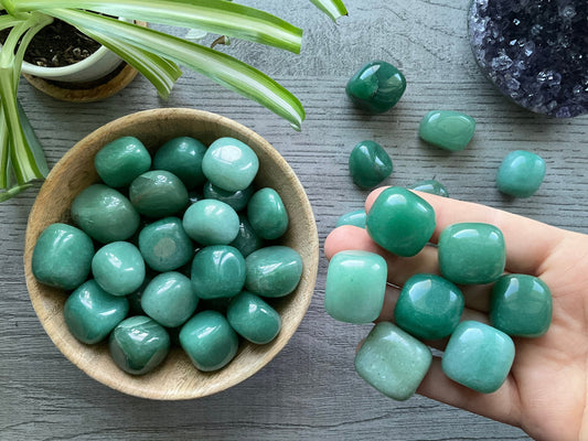 Pictured are green aventurine tumbled stones.