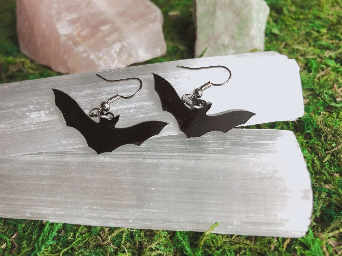 Pictured is a pair of black bat earrings made of acrylic. Black Bat Acrylic Earrings