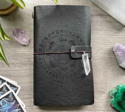 Pictured is a faux leather refillable notebook with a crystal. Faux Leather Divination Circle Refillable Notebook (Black) front