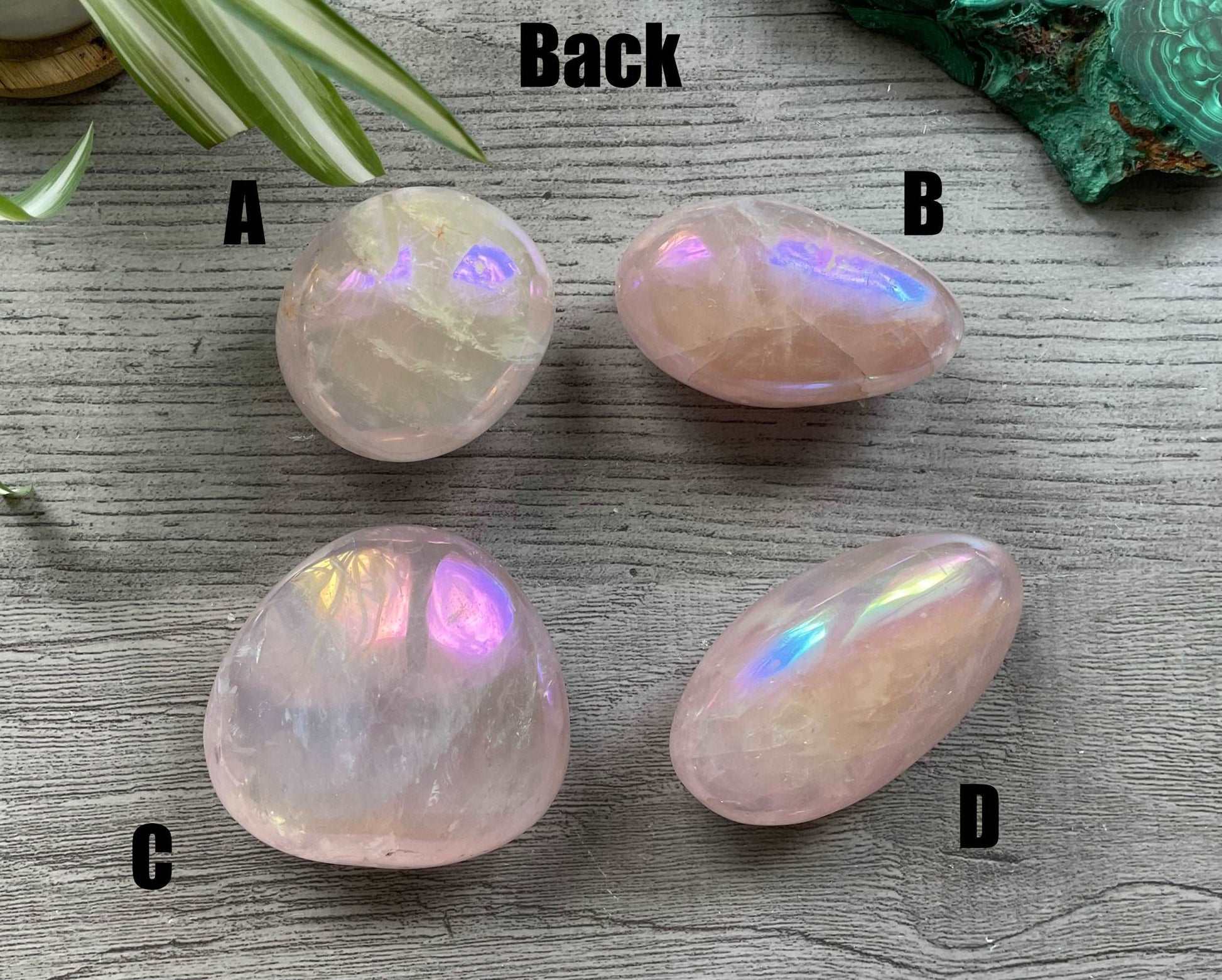 Pictured are various polished aura rose quartz palm stones. Aura Rose Quartz Palm Stone back