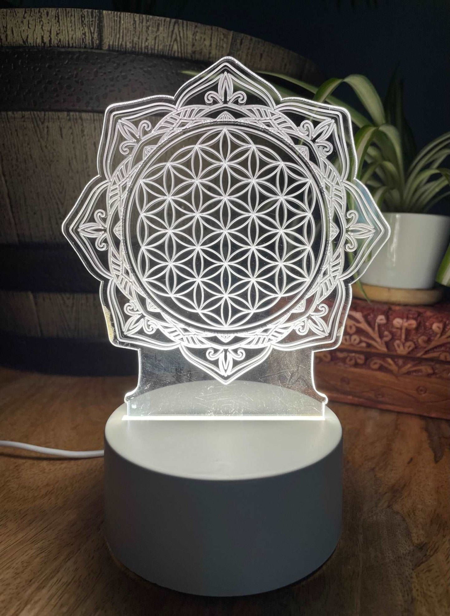 Pictured is a night light with an acrylic flower of life design. Flower of Life Acrylic Light