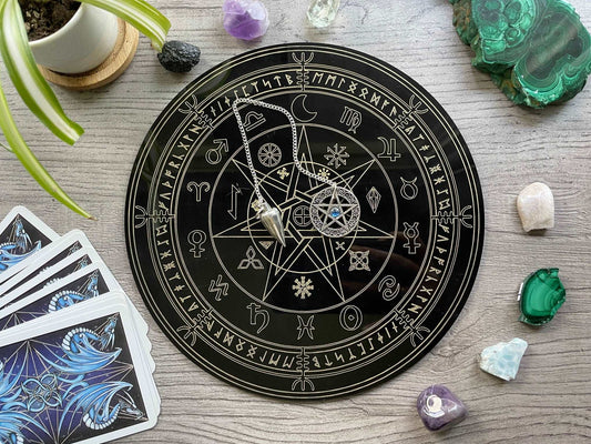 Pictured is a black acrylic divination board. Divination Board (Runes/Zodiac)