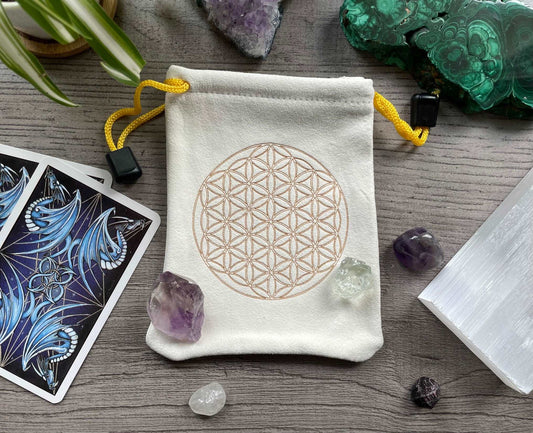 Pictured is a cream-coloured, faux-suede drawstring bag with a flower of life printed on the front. Flower of Life Faux Suede Drawstring Bag