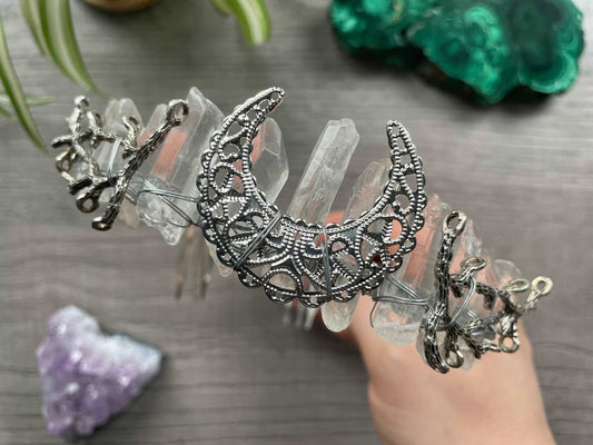 Pictured is a crown made with clear quartz points and a silver crescent moon. Clear Quartz Aura Crystal Crown - The Wandering Fox Emporium, Your Crystal Store