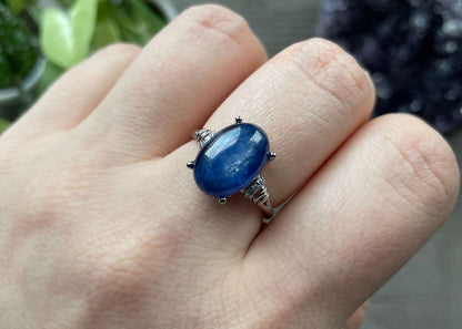 Pictured is a blue kyanite gemstone set in an S925 sterling silver ring. Blue Kyanite S925 Sterling Silver Ring (B) - The Wandering Fox Emporium, Your Crystal Store