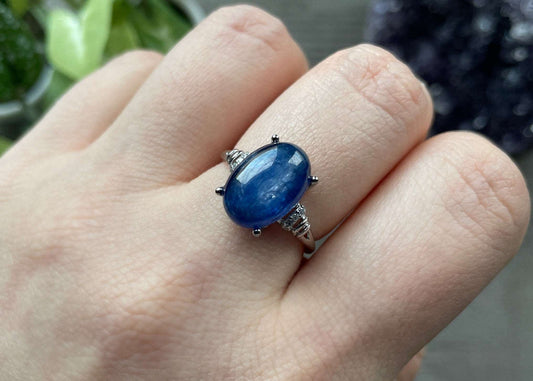 Pictured is a blue kyanite gemstone set in an S925 sterling silver ring. Blue Kyanite S925 Sterling Silver Ring (B) - The Wandering Fox Emporium, Your Crystal Store