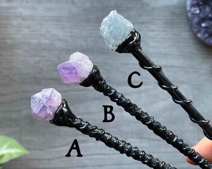 Pictured are various wood wands with crystals on top. Crystal & Wood Ritual Wand close up