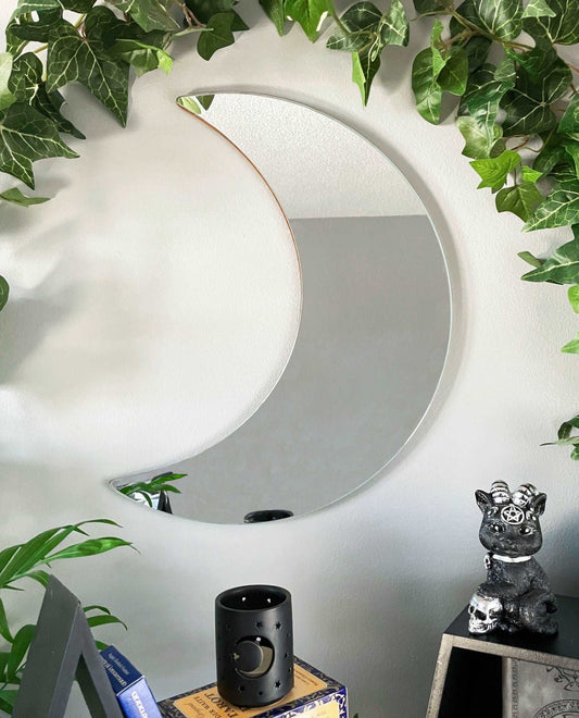 Pictured is a mirror shaped like a crescent moon. Crescent Moon Wall Mirror