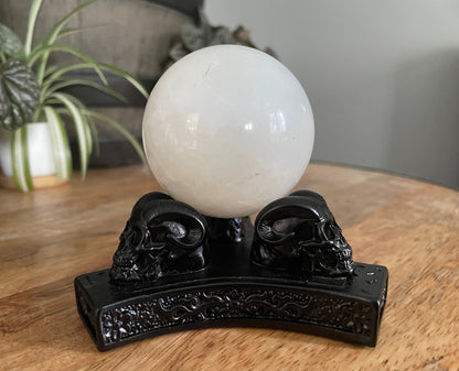 Pictured is a sphere stand in the shape of three demon skulls. Triple Demon Skull Crystal Sphere Stand side