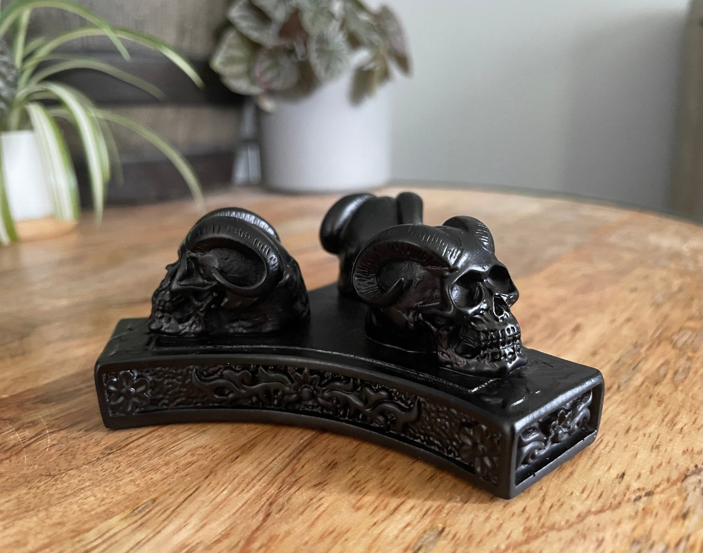 Pictured is a sphere stand in the shape of three demon skulls. Triple Demon Skull Crystal Sphere Stand close up