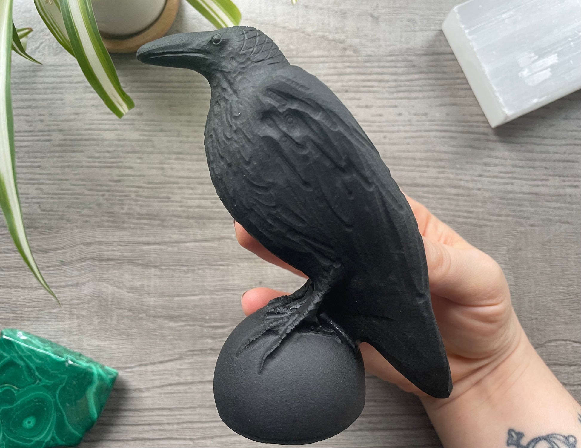 Pictured is a raven carved out of black obsidian.