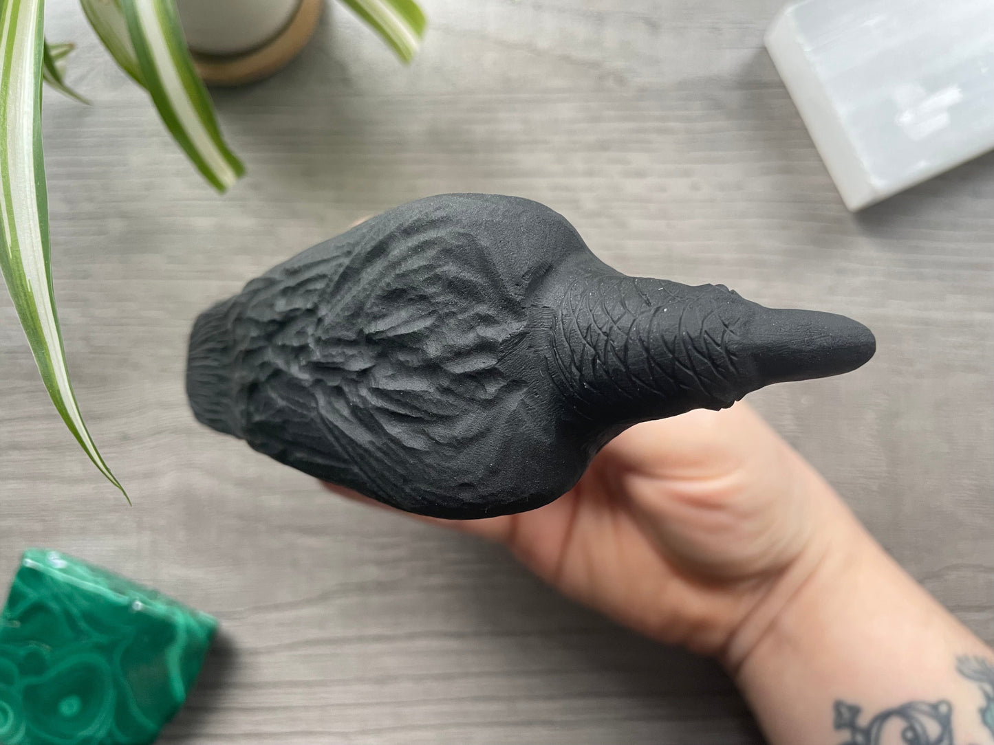 Pictured is a raven carved out of black obsidian.