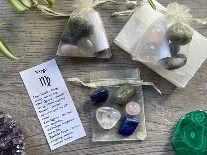 An image of a collection of tumbled stones in an organza bag. To the side is a piece of paper that describes what each tumbled stone's metaphysical properties are. VIRGO Zodiac Tumbled Crystal Bag 