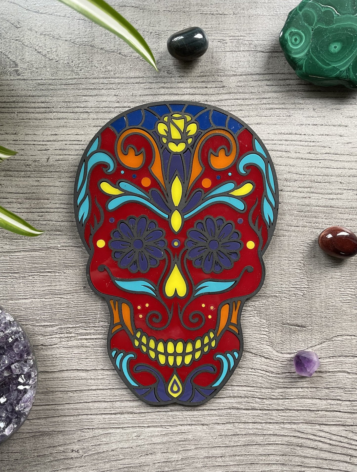 Pictured is a faux stained glass sugar skull made out of wood and acrylic. Sugar Skull Wall Art (Red) front