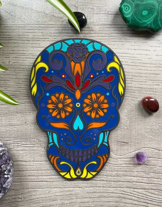 Pictured is a faux stained glass sugar skull made out of wood and acrylic. Sugar Skull Wall Art (Blue) front