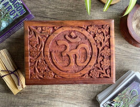 Pictured is hand-carved wood box with the "OM" symbol in the middle. OM Symbol Carved Wooden Box