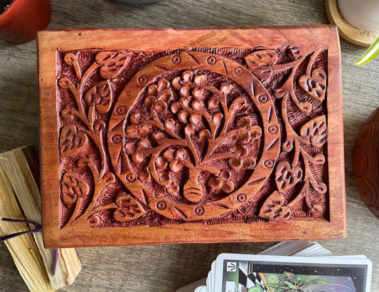 Pictured is hand-carved wood box with a tree of life in the middle. Tree of Life Carved Wooden Box