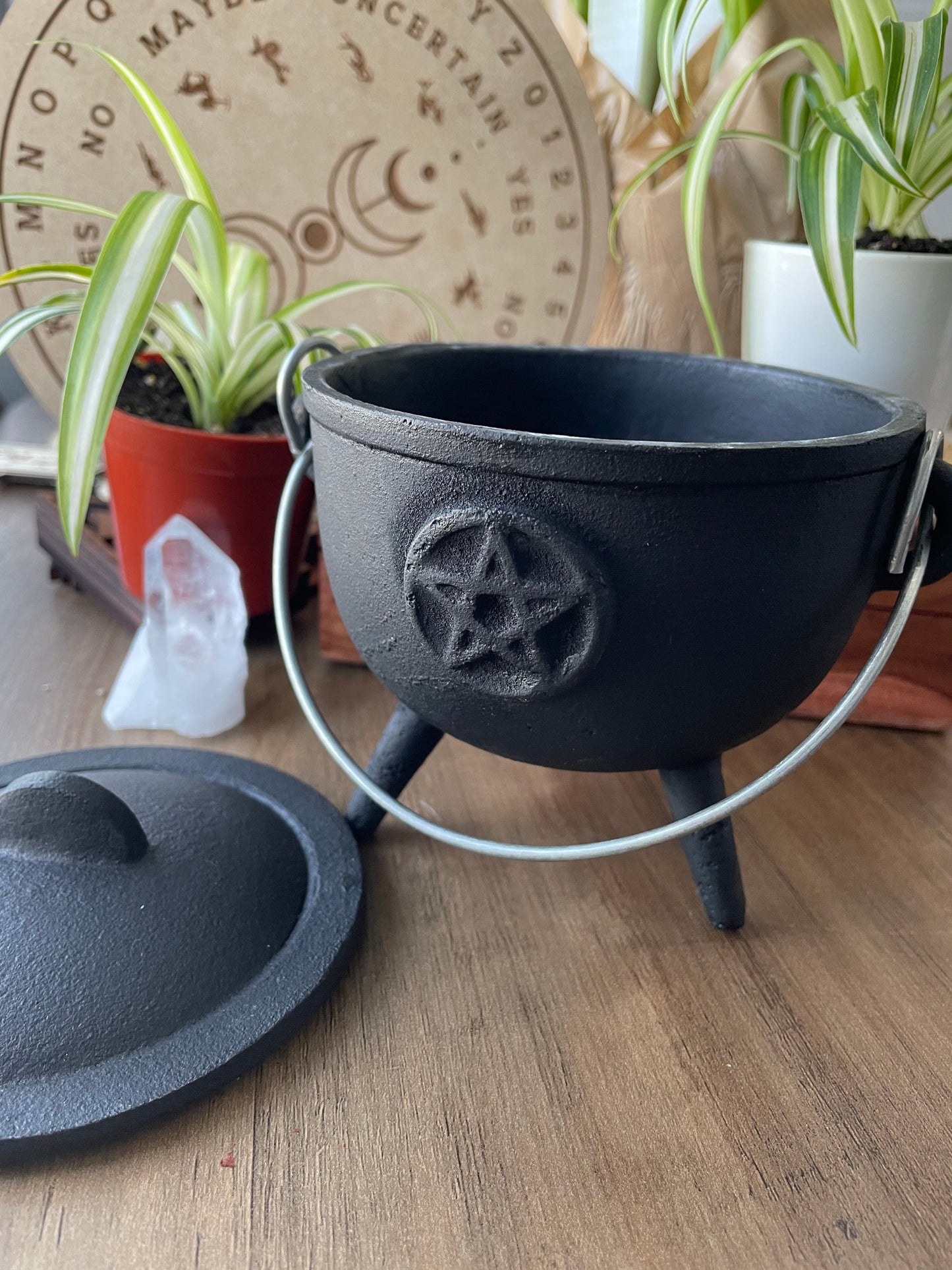 Pictured is a cast iron cauldron with lid. Pentacle Cast Iron Cauldron 12cm close up