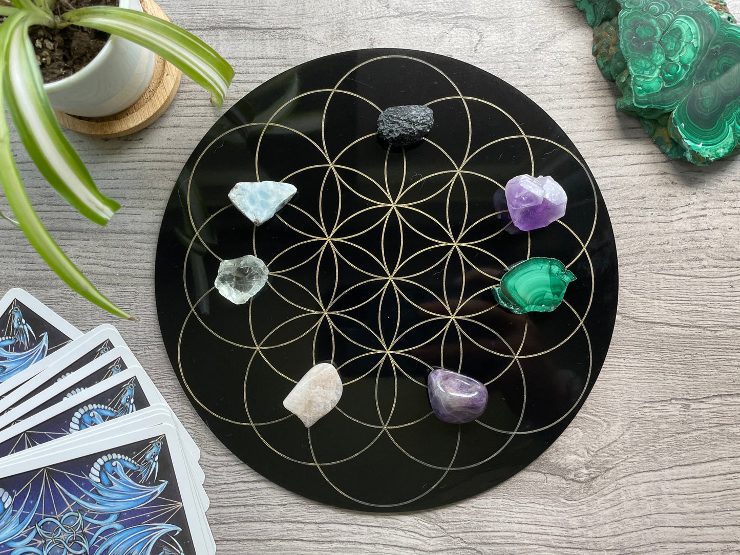 Pictured is a black acrylic crystal grid board. Seed of Life Crystal Grid