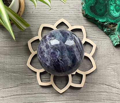 Pictured is a wood sphere stand in the shape of a flower. Wood Flower Crystal Sphere Holder example