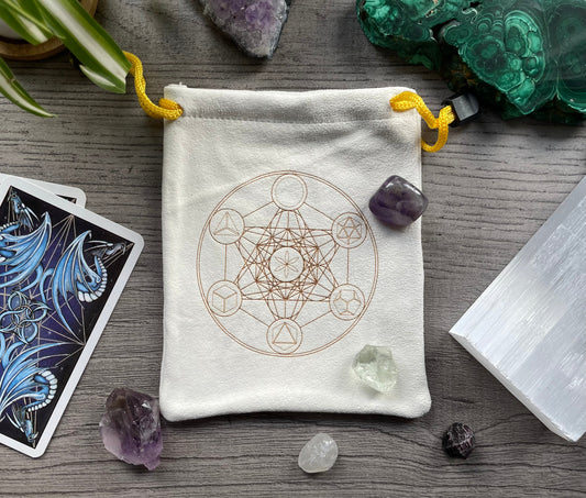 Pictured is a cream-coloured, faux-suede drawstring bag with a sacred geometry symbol printed on the front. Sacred Geometry Suede Drawstring Bag