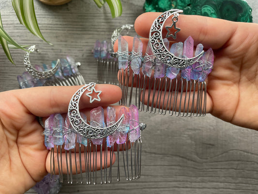 Pictured are various aura quartz hair combs with silver crescent moons on them. Pink & Blue Quartz Aura Crystal Comb - The Wandering Fox Emporium, Your Metaphysical Store