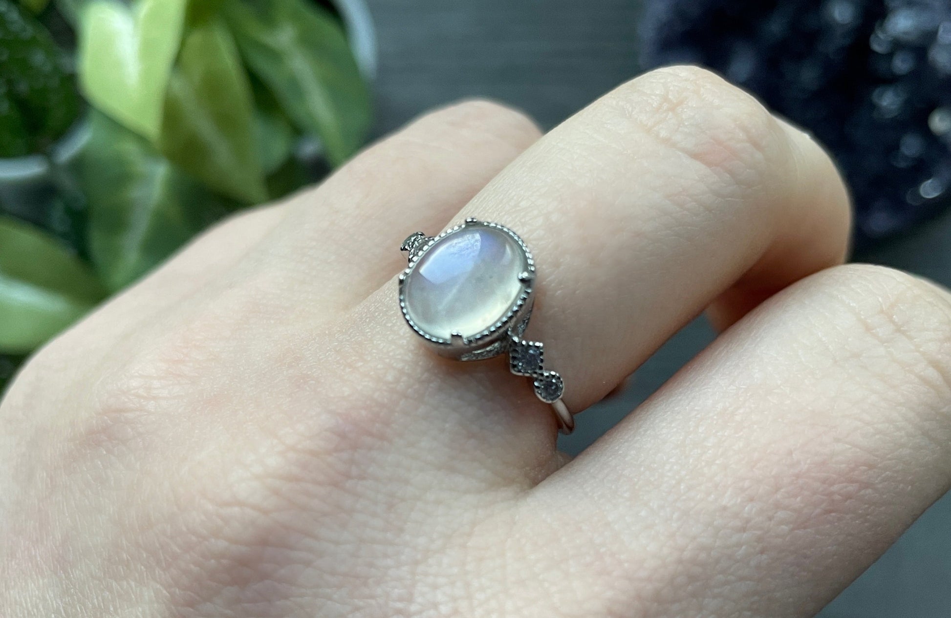 Pictured is a white moonstone gemstone set in an S925 sterling silver ring. White Moonstone S925 Sterling Silver Ring (Style 2 - D) - The Wandering Fox Emporium, Your Crystal Store side