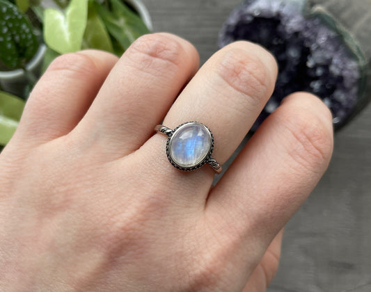 Pictured is a white moonstone gemstone set in an S925 sterling silver ring. White Moonstone S925 Sterling Silver Ring (J) - The Wandering Fox Emporium, Your Crystal Store