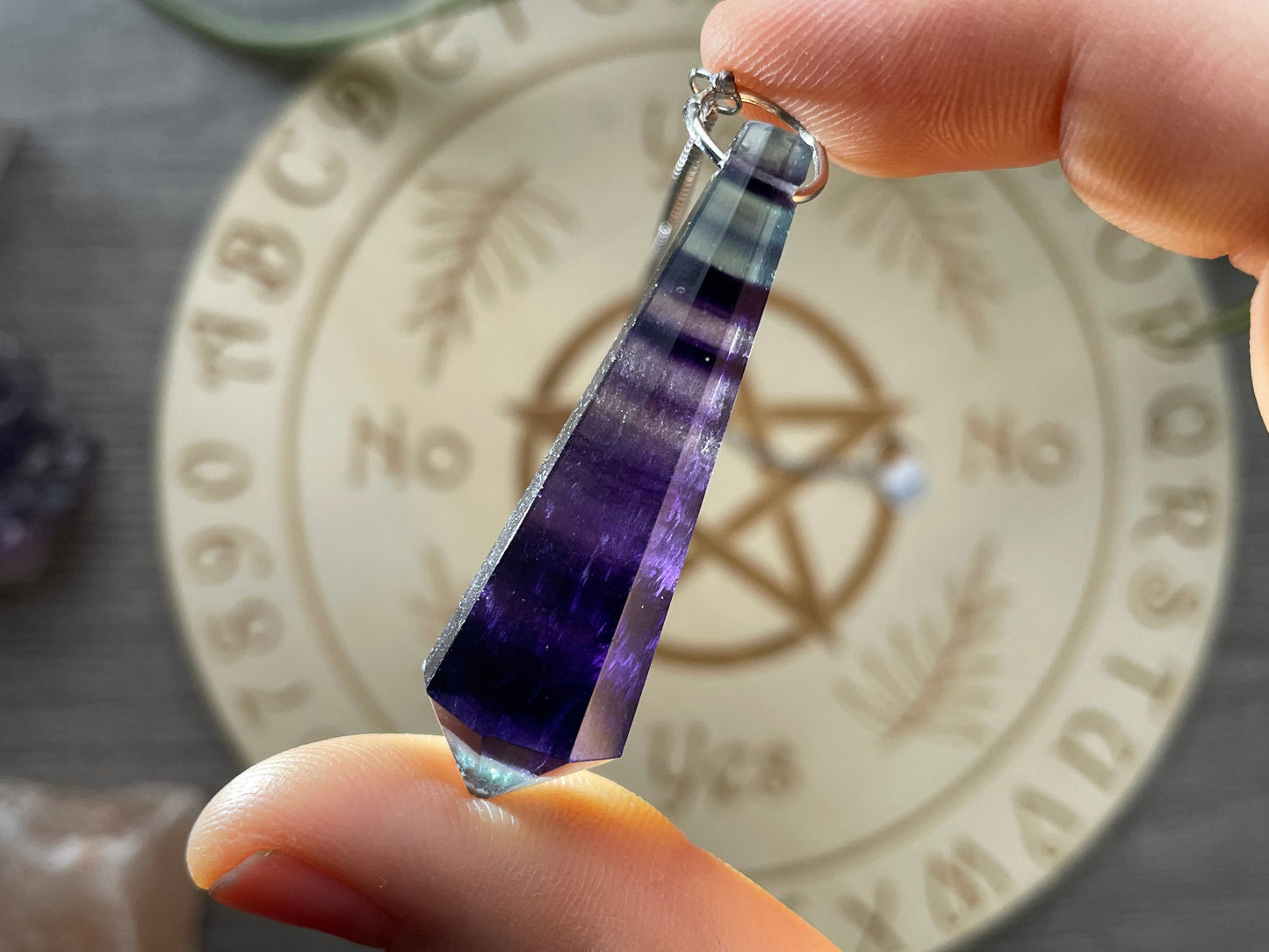 Rainbow Fluorite 8-Sided Crystal Pendulum (D) backlit