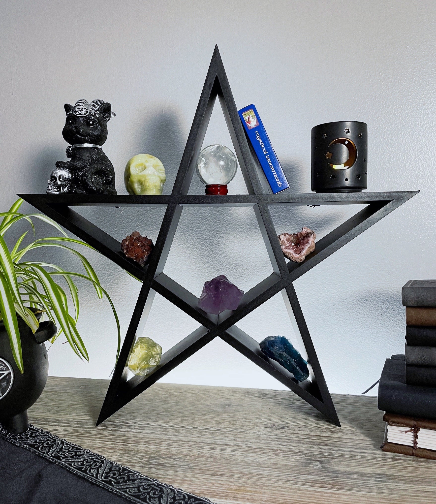 Pictured is a shelving unit shaped like a pentagram Pentagram Shelving Unit