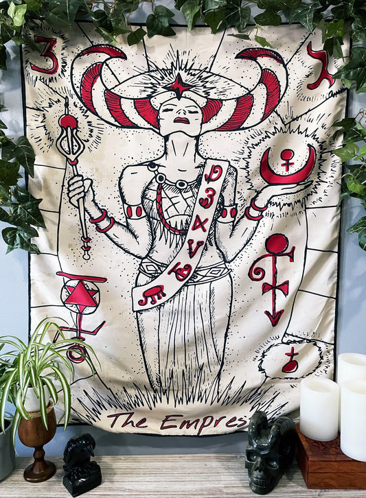 Pictured is a large wall tapestry with a white background and a tarot card of "the empress" printed in black and red on it. The Empress Wall Tapestry