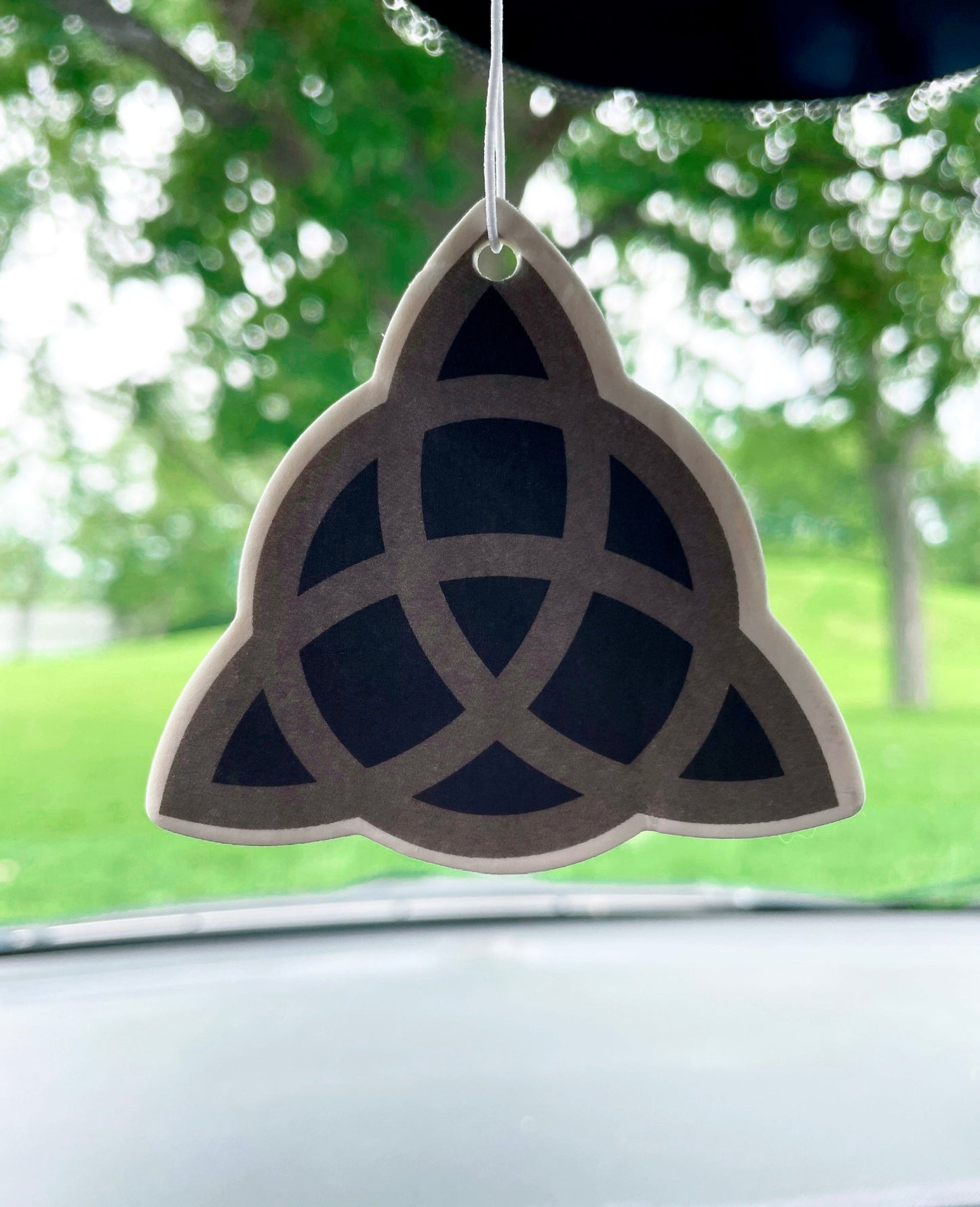 Pictured is an air freshener in the shape of a triquetra Triquetra Air Freshener (Vanilla Scent)