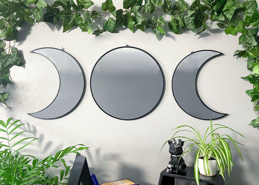 Pictured is a mirror in three pieces shaped like a triple moon three phases of the moon. Triple Moon Wall Mirrors