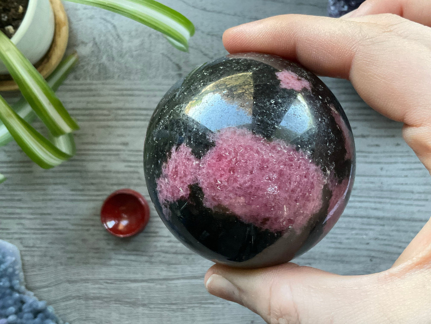 Rhodonite Sphere - 65mm - The Wandering Fox Emporium, Your Crystal Store front